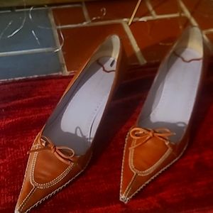 Sleek Nine West pointy toe shoe has an edgy outer stitching and a dainty bow.